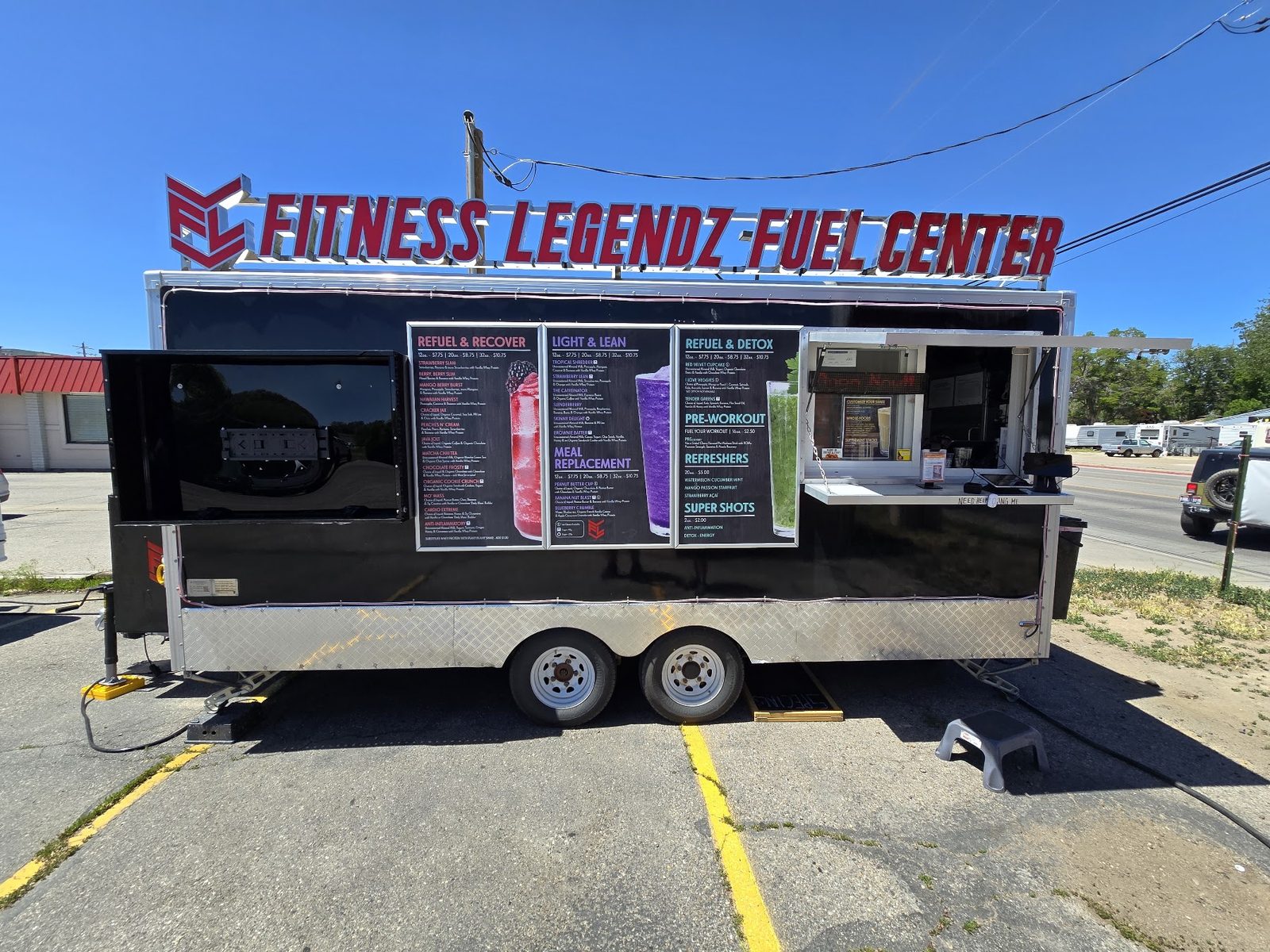 The Fitness Legendz Fuel Center trailer parked outside the gym, menu boards on the side